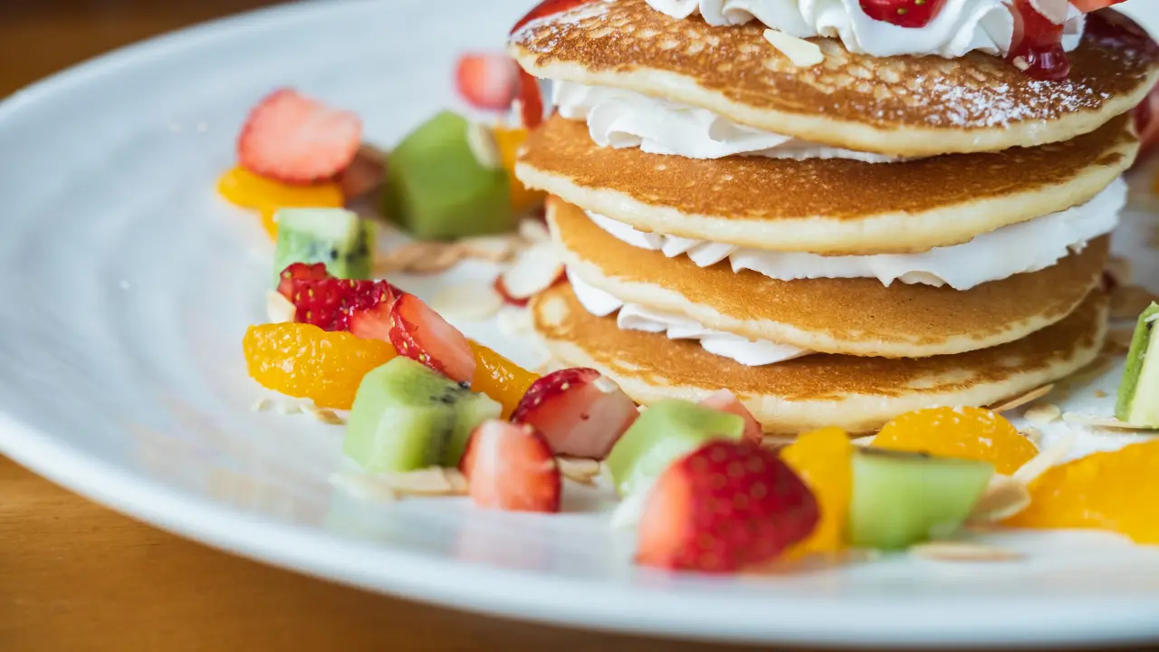 adding fruit to pancake mix